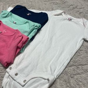 Carters long sleeved onesies. White, navy blue, teal and pink.